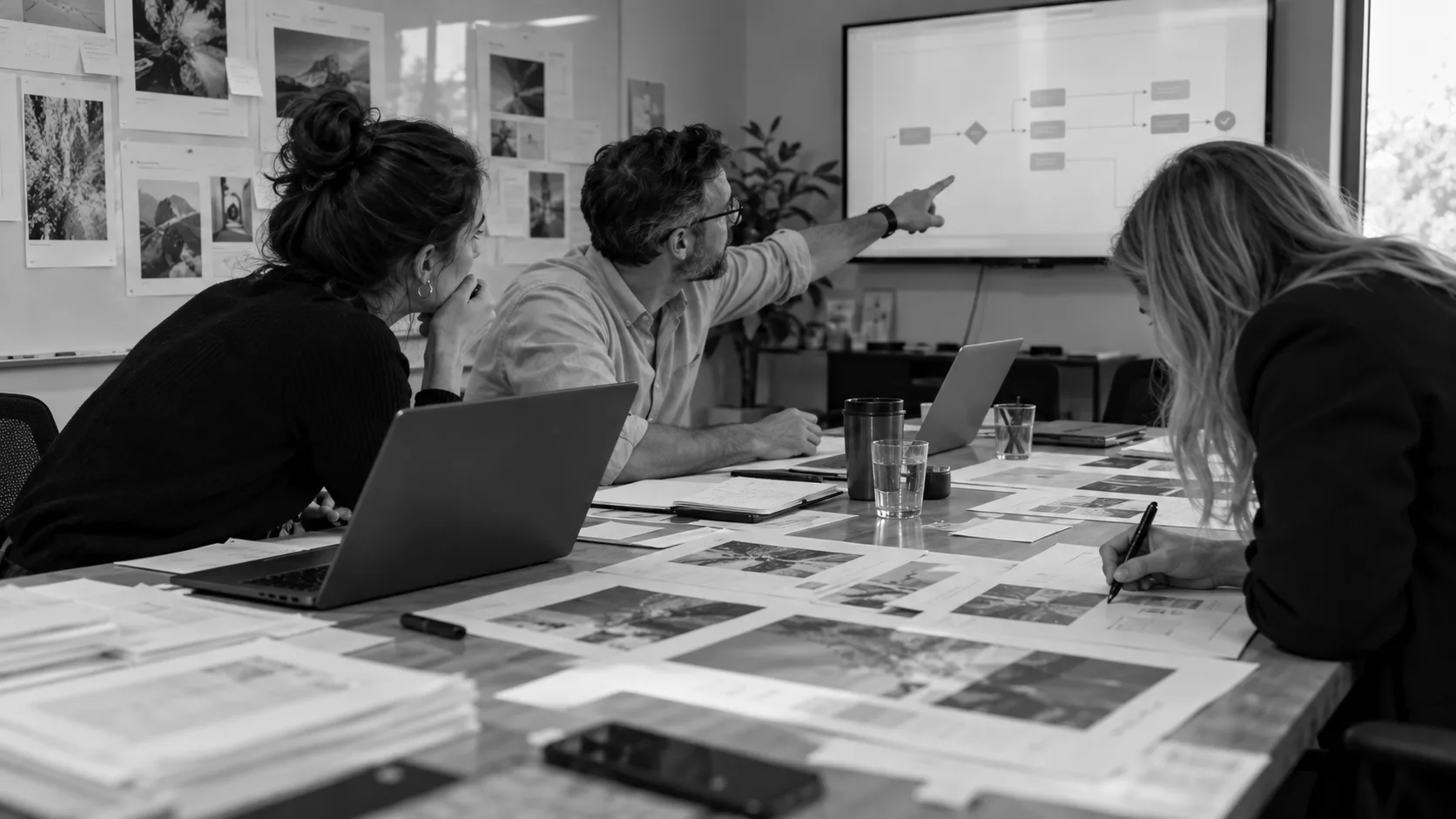 Team reviewing a process flow on a wall display during CoCo planning